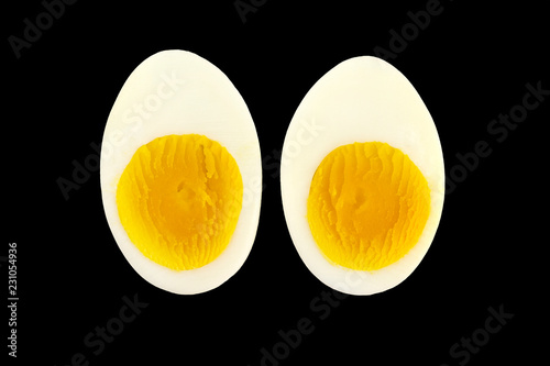 Boiled egg slices  isolated on black background.