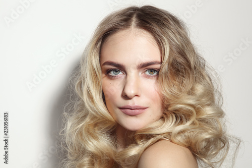 Young beautiful blonde woman with long curly hair