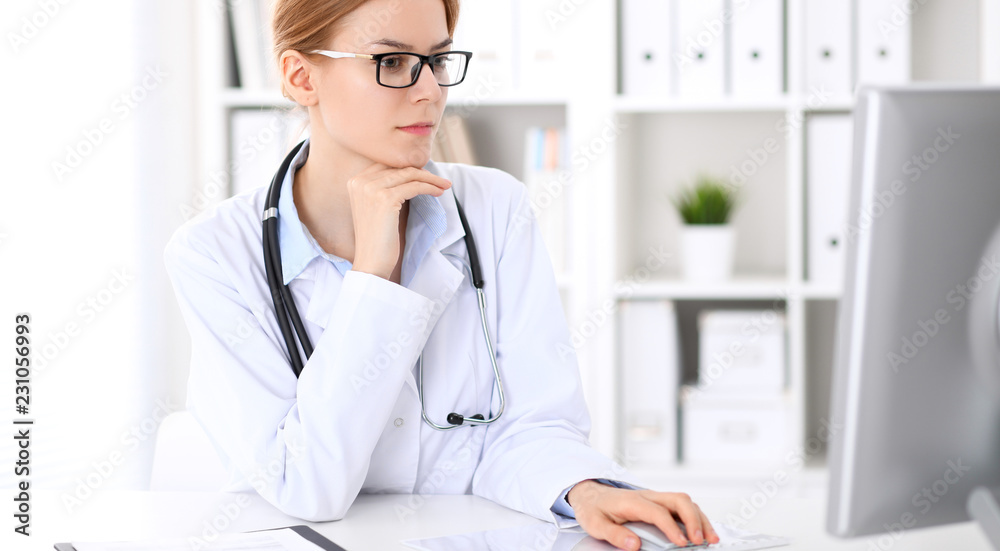 Young brunette female doctor at work in hospital. Physician ready to help. Medicine and healthcare concept Young brunette female doctor at work in hospital. Physician ready to help. Medicine and healthcare concept