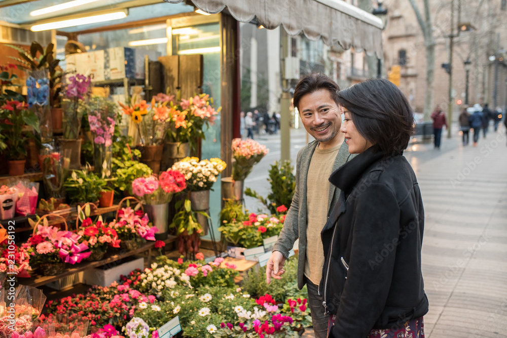 Asian couple shopping flowers in barcelona