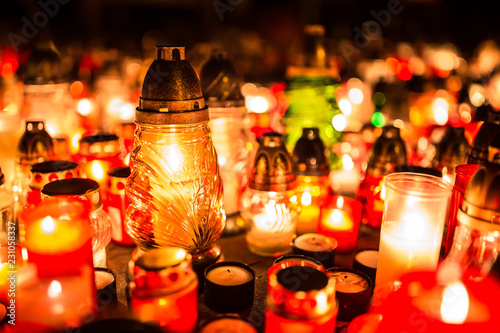 Many burning candles in the cemetery at night on the occasion souls of the deceased