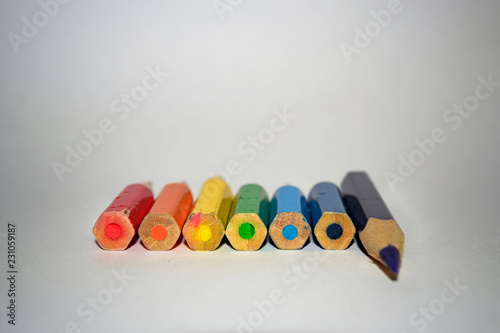 colored pencils, colors of the rainbow, lie in a row