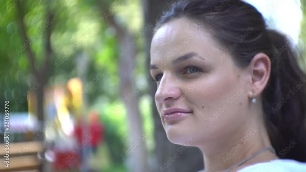 Casual close up portrait of young woman smiling outside