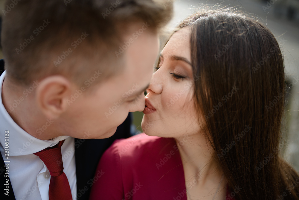 Sexy passion couple in love. Portrait of beautiful young man and woman dressed in classic clothes, studio shot over grey background Sexy passion couple in love. Portrait of beautiful young man and woman dressed in classic clothes, studio shot over grey background