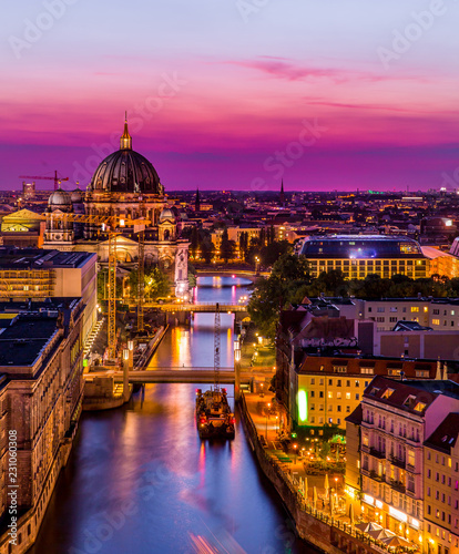 aerial view of Berlin skyline with Berlin Cathedral and Spree river in beautiful post sunset twilight during blue hour at dusk with dramatic colorful clouds , central Berlin Mitte, Germany