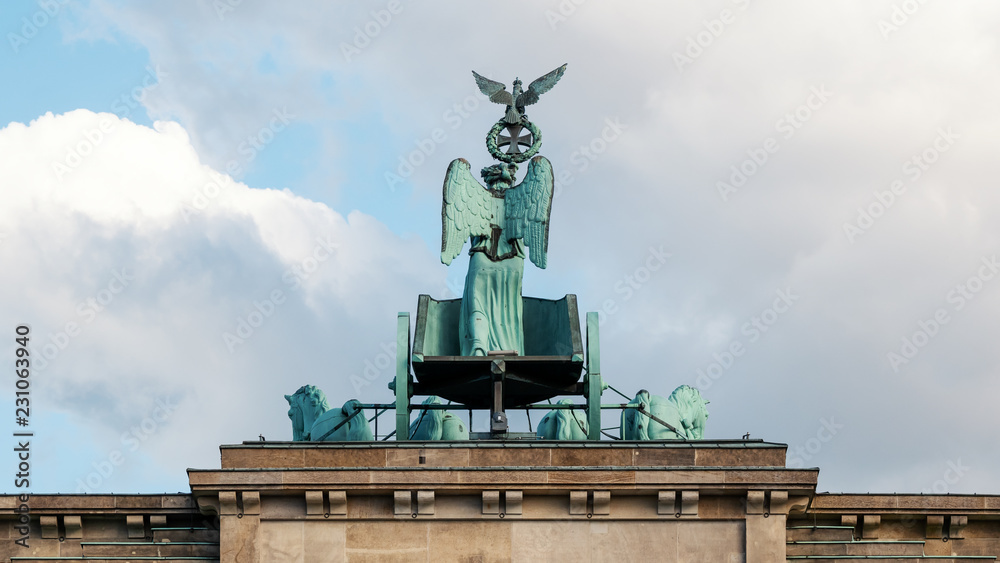 Fototapeta premium The Quadriga of Brandenburg Gate Against A Blue Cloudy Sky In Berlin, Germany