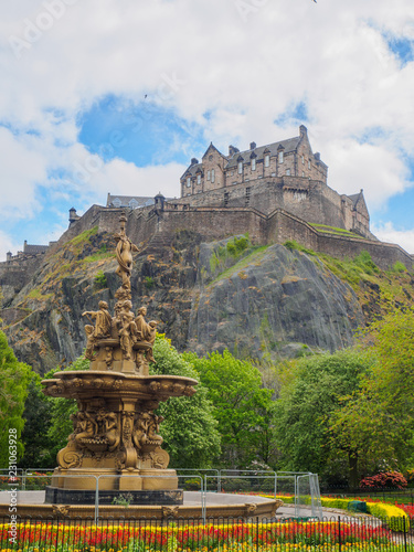 Edinburgh Castle and Ross Fountain seen from the Princes Street Gardens on a bright sunny day.