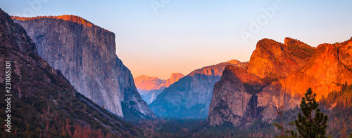 Yosemite National Park Tunnel View overlook at sunset. Front view panorama of popular El Capitan and Half Dome at deep red sunset. Summer american holidays. California, United States. photo
