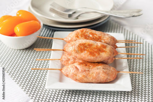 Minced turkey kebabs on square white plate photo
