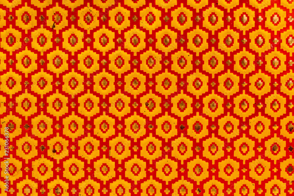 Metallic texture of red and yellow hexagons. Pattern. Retro look, old and shiny.