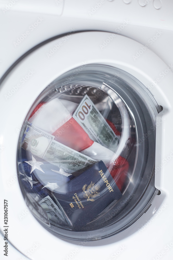 American passport, flag and money in washing machine. Concept of money laundering.