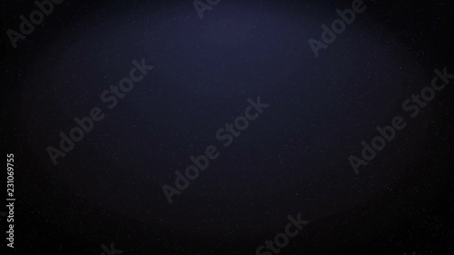 Little particles of dust, stardust or micro parts flying and moving on the dark blue background.