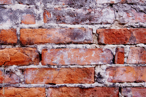 Old wall background of bricks with cracks, fissures, crevices