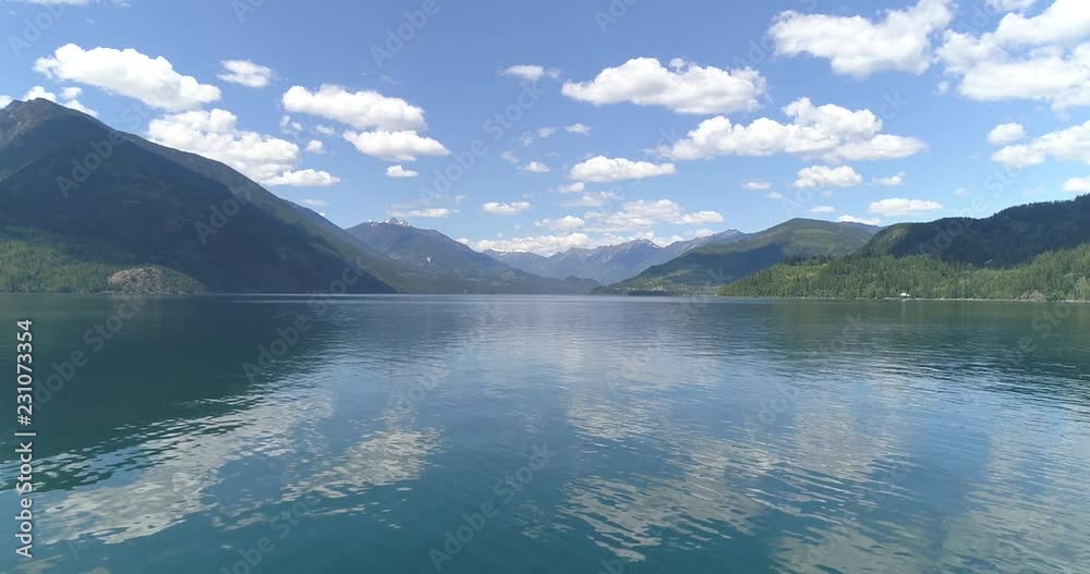 Aerial View at Mountain on sunny and cloud fall afternoon Lake in British Columbia, Canada. Mountains background. Aerial View at Mountain on sunny and cloud fall afternoon Lake in British Columbia, Canada. Mountains background.