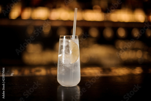 Tableau sur toile Tom Collins cocktail in the glass with tubule and lemon