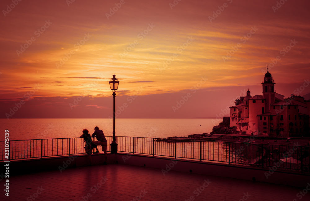 Couple admires the sunset on the sea