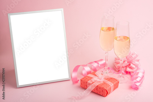 Champagne, gift, bow. Invitation, birthday, party on the occasion of girlhood, the concept of a baby shower, a holiday on a pink background. Banner for inscriptions, announcements for birthday