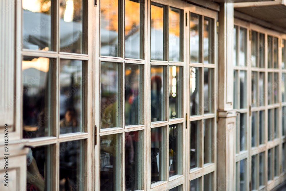 panoramic wooden windows showcase a cafe shop in retro style, the window frame made of wood is a close-up of the panoramic window nobody. panoramic wooden windows showcase a cafe shop in retro style, the window frame made of wood is a close-up of the panoramic window nobody.