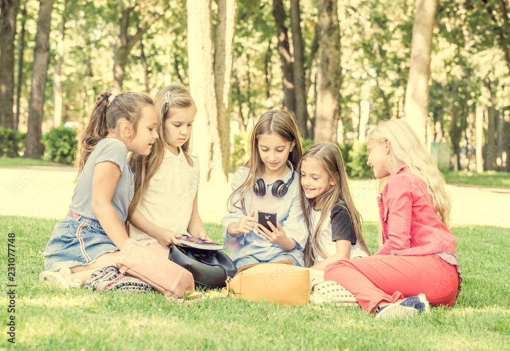 Friendly teens sitting in the park Friendly teens sitting in the park