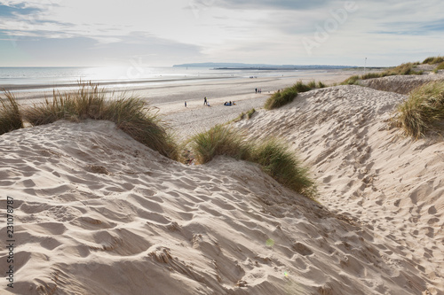 Camber Sands, sandy beach at the village of Camber, East Sussex near Rye, England, the only sand dune system in East Sussex. View of the dunes, grass, sea, selective focus photo