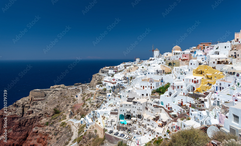 Panoramic view on mountain architecture of Oia town at Santorini island, Greece