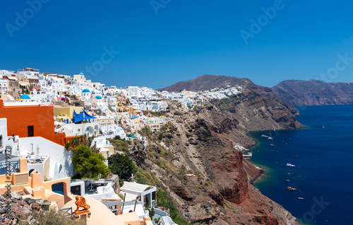 Panoramic view on mountain architecture of Oia town at Santorini island, Greece
