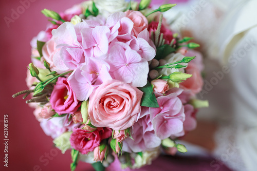 Wedding bouquet of flowers including Red hypericum  Roses  Lilies of the valley  mini Roses  Seeded Eucalyptus  Astilbe  Scabiosa  Pieris  and ivy