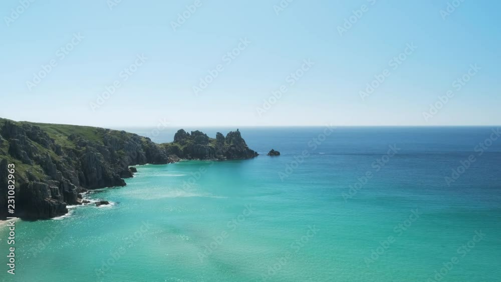 Views across Pedn Vounder Beach towards Logan's Rock, Cornwall, England on a clear sunny June day. Views across Pedn Vounder Beach towards Logan's Rock, Cornwall, England on a clear sunny June day.