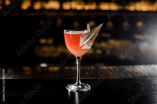 Decorated glass filled with fresh Paper Plane cocktail