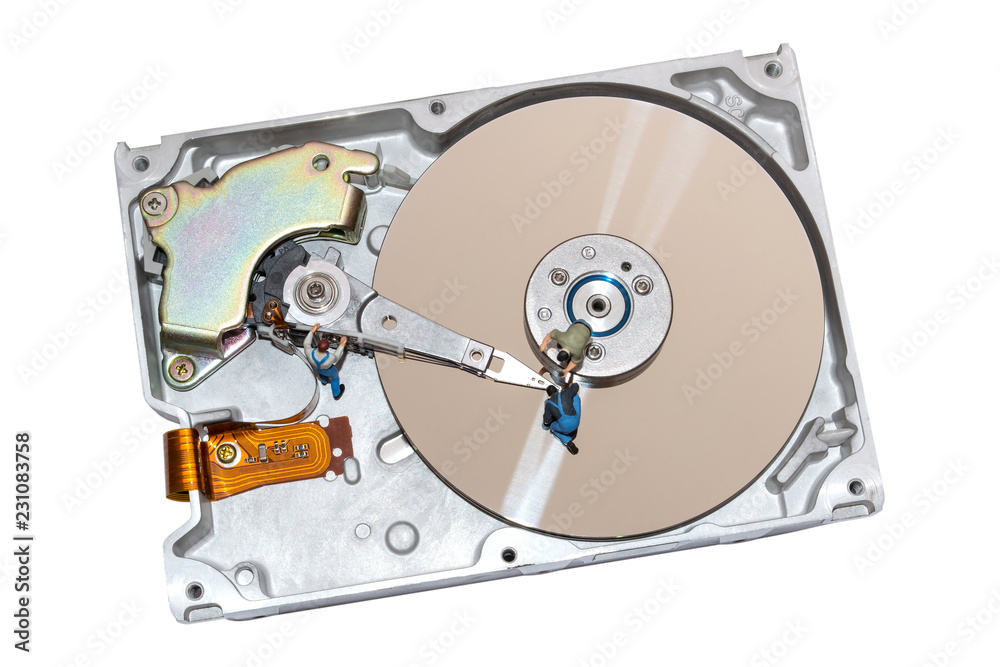 Creative concept with miniature people repairing the hard drive Creative concept with miniature people repairing the hard drive