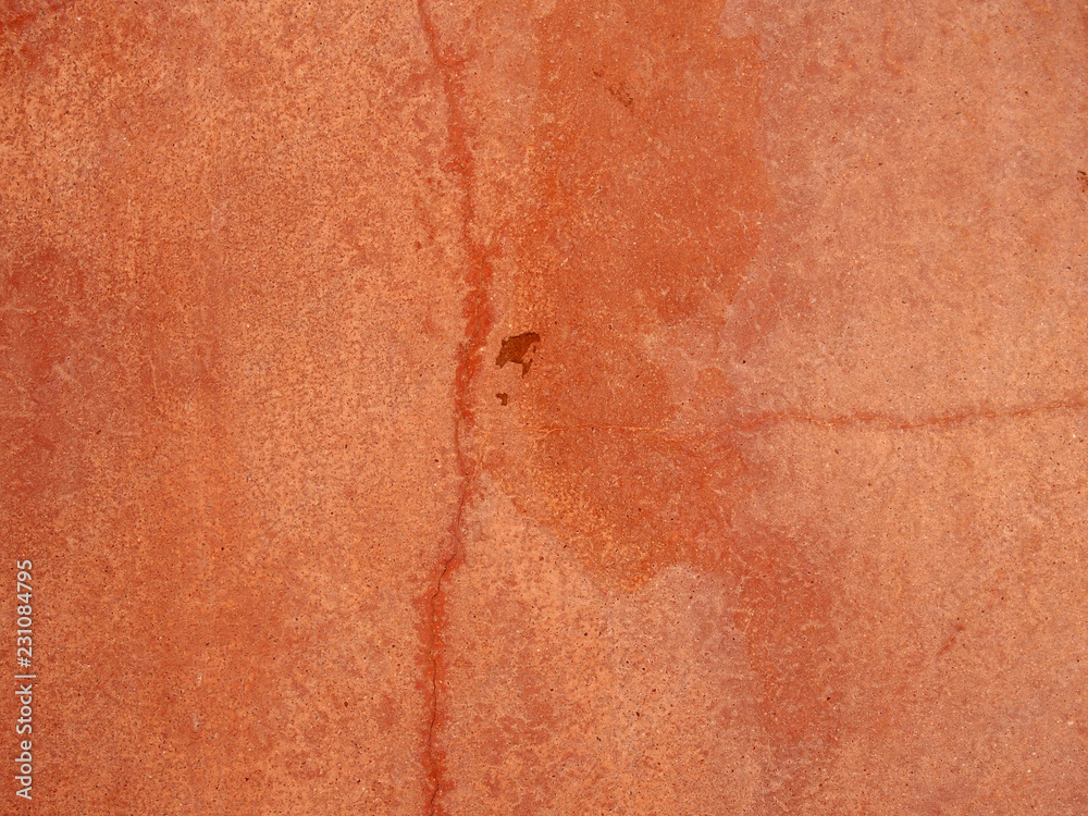 an old faded red cracked rough textured painted concrete wall background an old faded red cracked rough textured painted concrete wall background