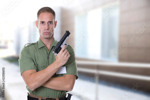 security agent with green shirt guarding a building