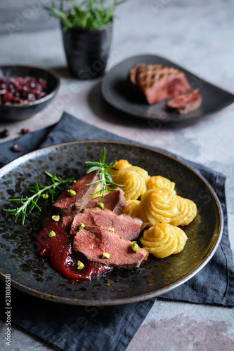 Duck breasts with Pommes Duchesse, cranberry sauce and pistachios