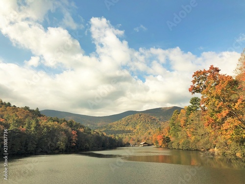 Fantastic view of colorful mountain with reflection in the lake at Vogel State park with blue sky white clouds on the background, Autumn in GA USA. photo