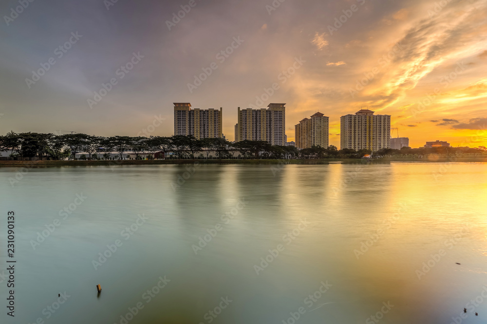 Obraz premium Beautiful landscape abstract citybackground and The light of sun reflection building on water.Panoramic and perspective wide angle skyscraper commercial modern city of future. pastel concept.