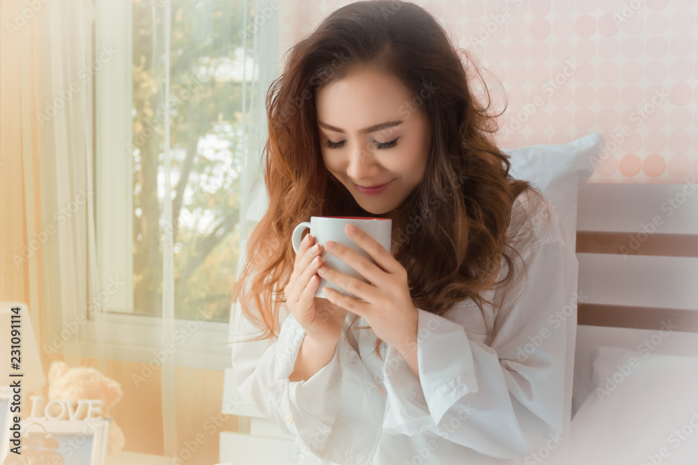young beautiful woman smell of coffee mugs in bedroom young beautiful woman smell of coffee mugs in bedroom