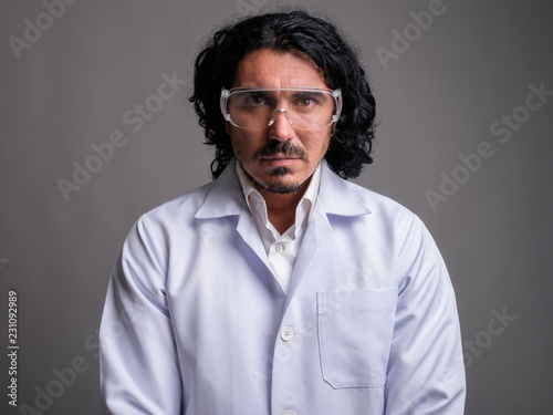 Scientist man doctor with mustache wearing protective glasses