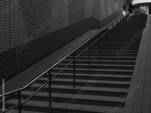 A women leaving up an empty staircase