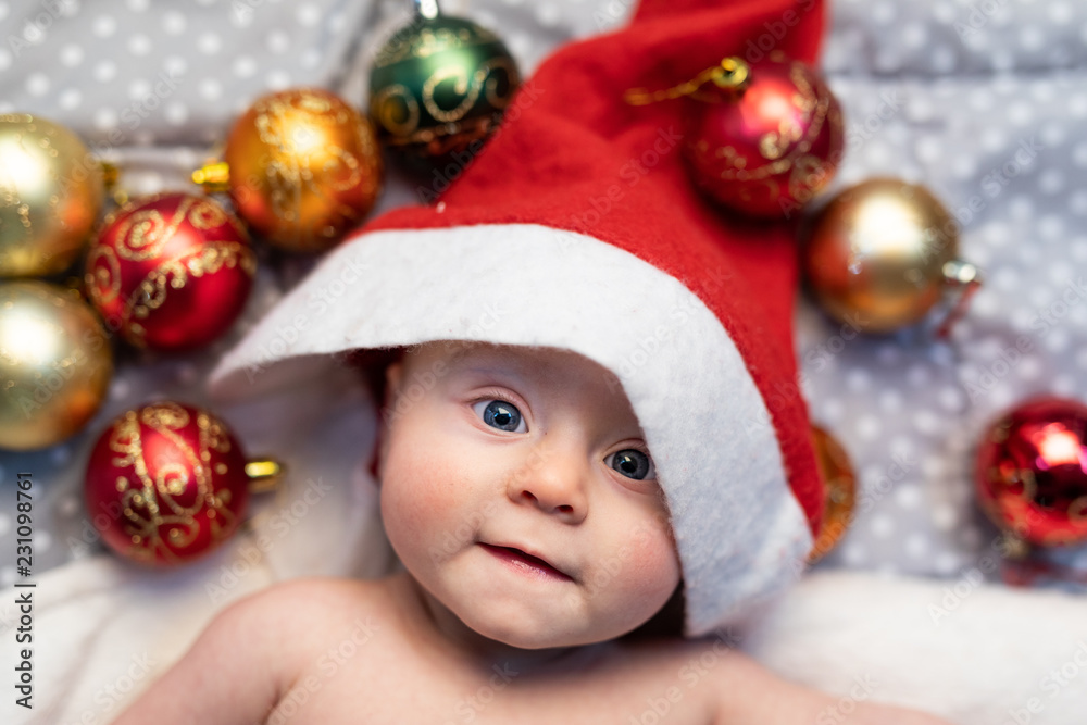 Adorable little baby dressed in a Santa hat Adorable little baby dressed in a Santa hat