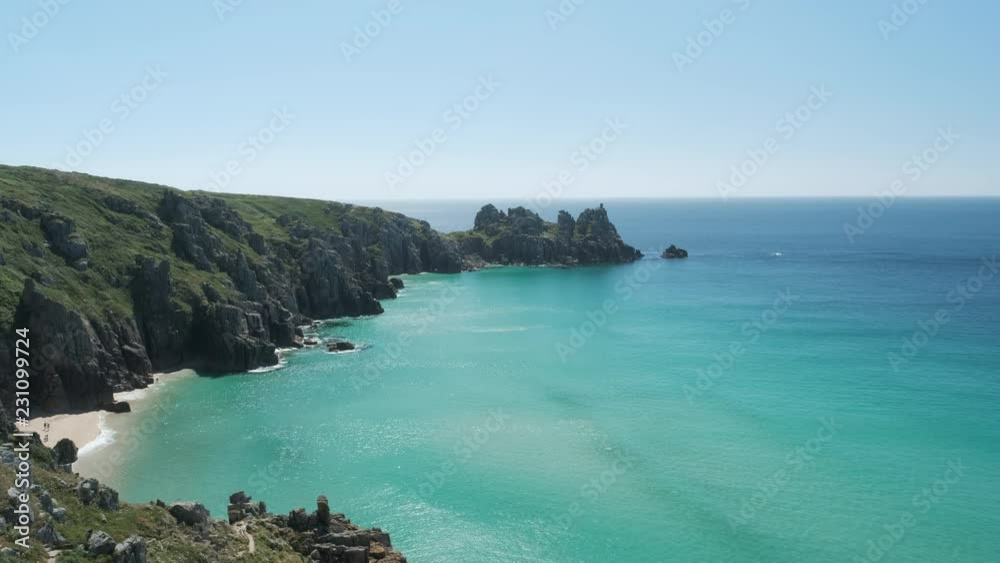 Views across Pedn Vounder Beach towards Logan's Rock, Cornwall, England on a clear sunny June day. Views across Pedn Vounder Beach towards Logan's Rock, Cornwall, England on a clear sunny June day.