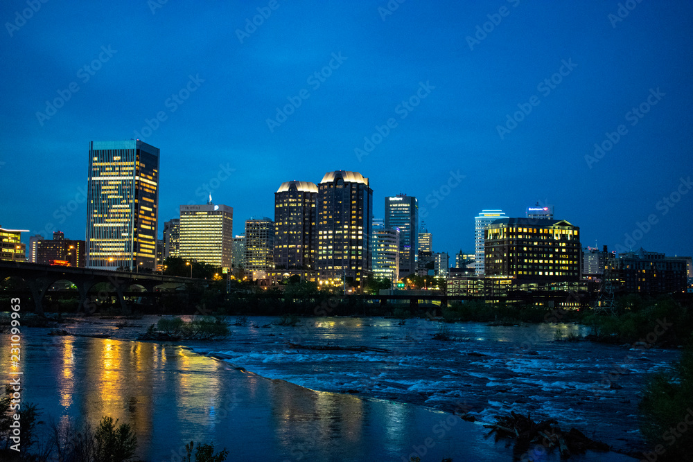 Nightime cityscape view of Richmond, Virginia, USA across the James River