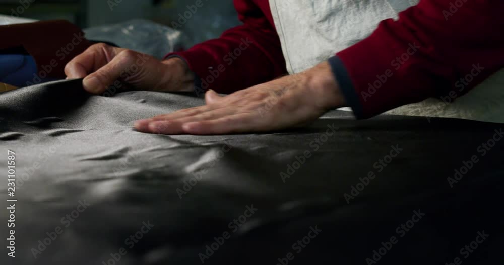 Close up of a shoemaker working a fabric in a shoe factory he is using the italian tradition. Close up of a shoemaker working a fabric in a shoe factory he is using the italian tradition.