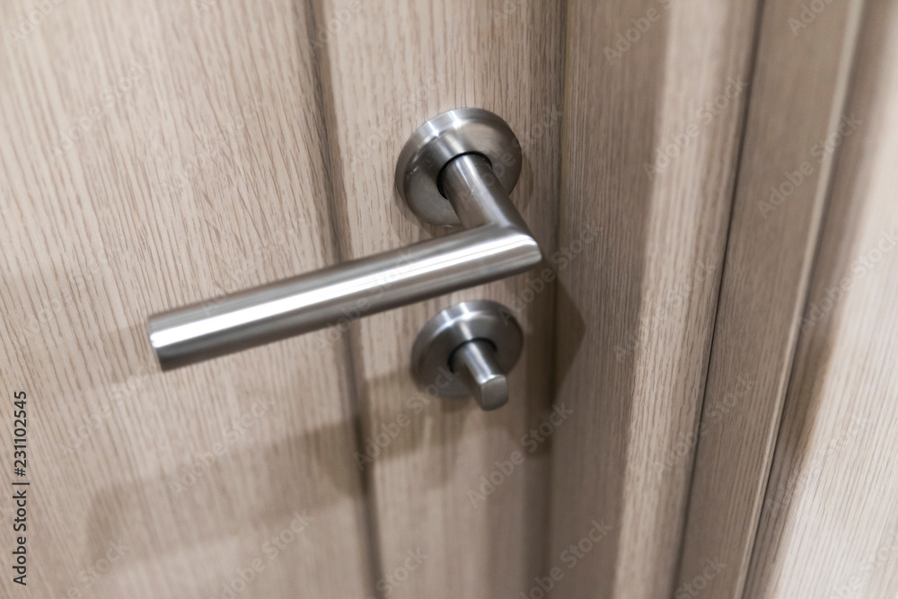 Detail of wooden door. Door handle close-up with blurred background. Detail of wooden door. Door handle close-up with blurred background.