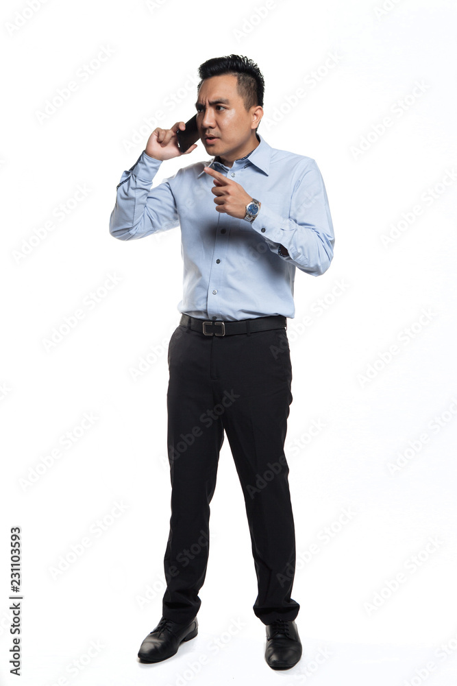 Asian man being angry while talking over the phone Asian man being angry while talking over the phone