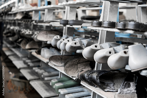 The conveyor on a shoes factory with shoe and sole. Mass production of footwear. photo
