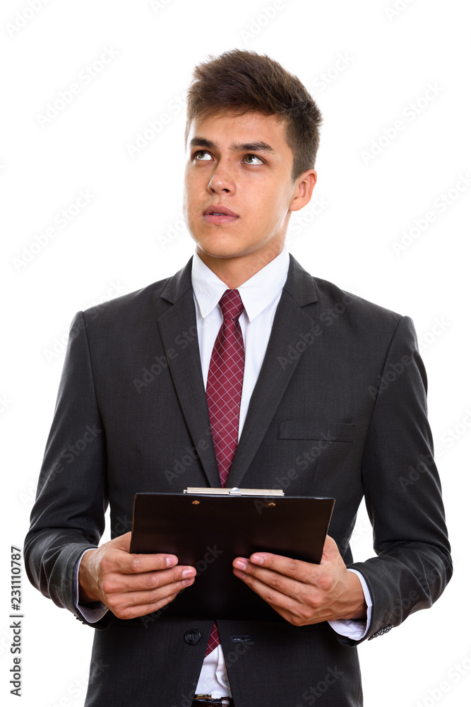 Young handsome businessman holding clipboard while thinking Young handsome businessman holding clipboard while thinking