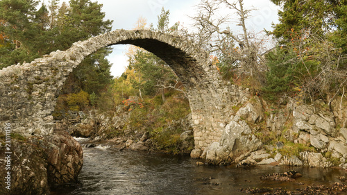 The fabulous old packhorse bridge in Carrbridge in the Cairngorms National Park is the oldest stone bridge in the Highlands of Scotland. photo