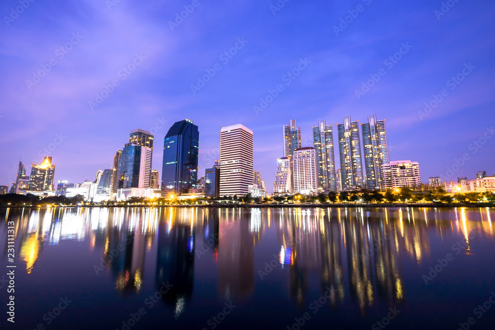 Fototapeta premium High buildings reflect the lake at night in Bangkok, Thailand.