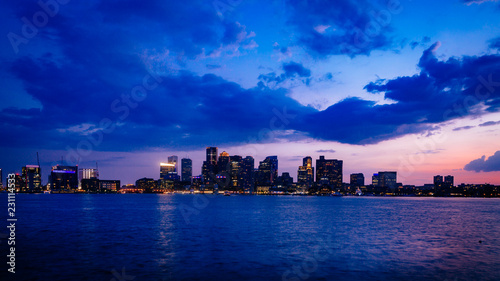 Skyline of downtown Boston over water at sunset, in Boston, USA