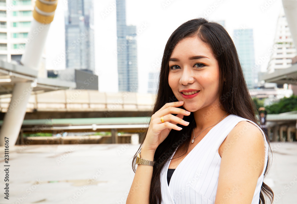 Beautiful Asia girl smile portrait on walking street and building background.. Beautiful Asia girl smile portrait on walking street and building background..